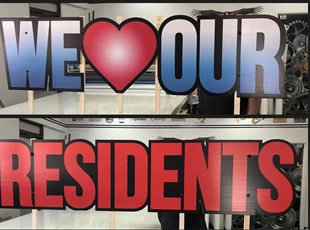 Routed Coroblast Signs for We Love Our Residents