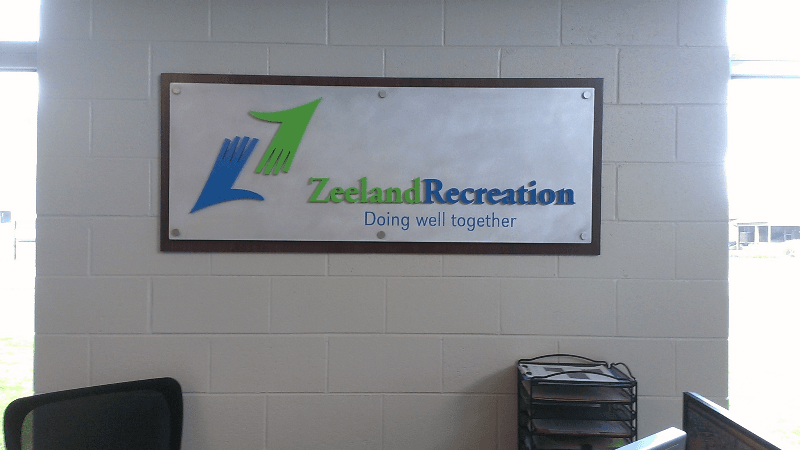 Wood block with steel sheet on stand offs and painted PVC letters