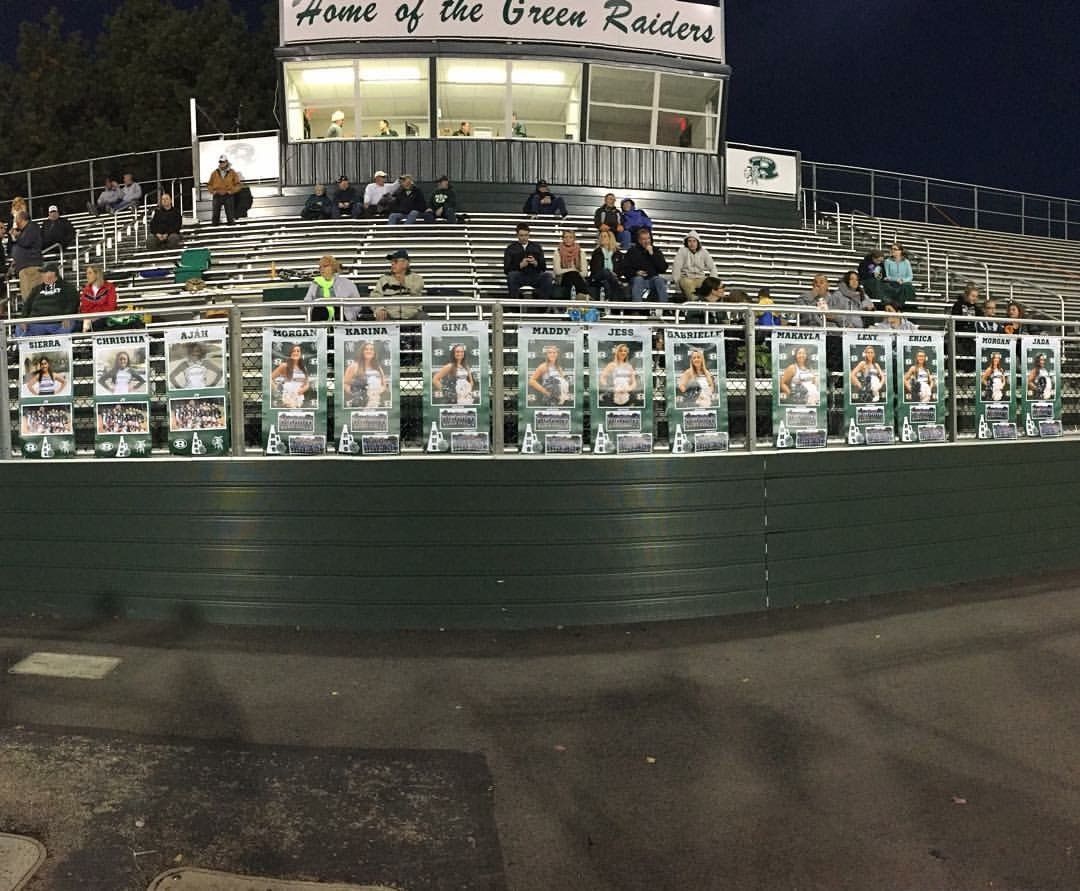 multiple student highlight banners hung across the front of bleachers