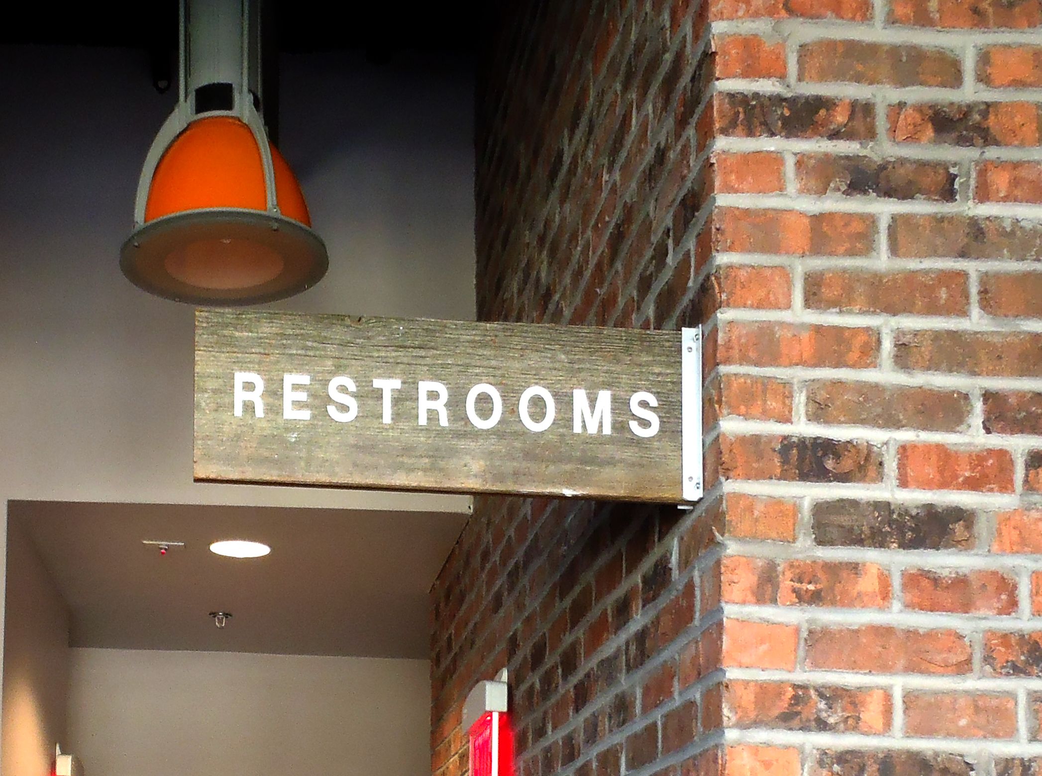 directional wayfinding mounted wooden restroom sign