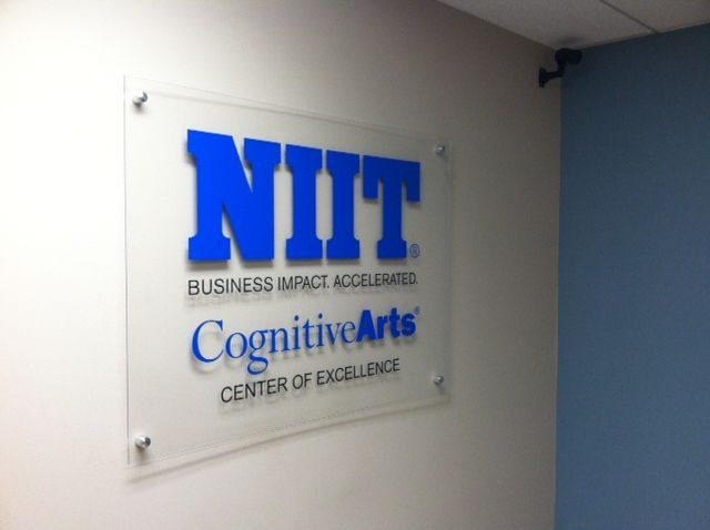 Clear acrylic sign with digitally printed contour cut lettering and standard brushed silver stand offs.