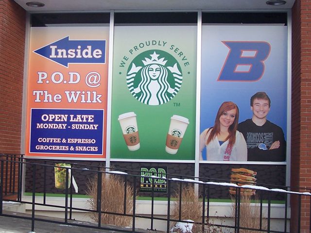 Full color vinyl window graphics promote services and provide directions as well