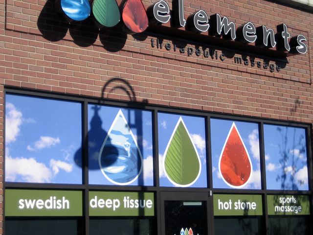 Full color vinyl covering the top windows make a pop of color on Elements storefront