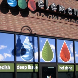 Full color vinyl covering the top windows make a pop of color on Elements storefront