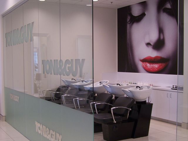 Frosted vinyl gives an elegant touch and the large wall mural in the back makes a bold statement