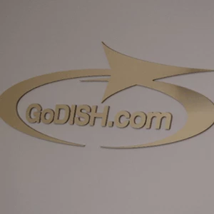 Dimensional logo using acrylic and brushed gold laminate