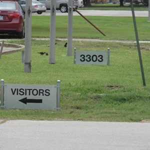 Metal sign for address and visitors for parking