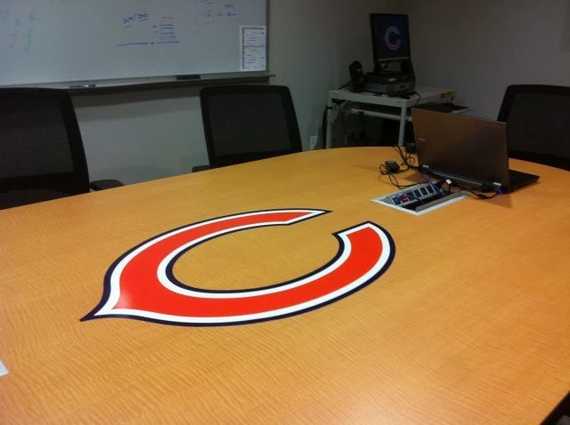 Digitally printed Logo applied to a conference table in Halas Hall