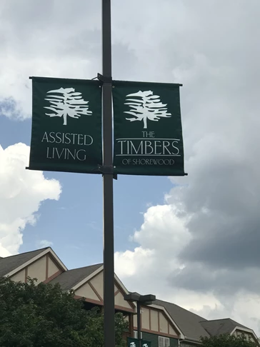Forest green Sunbrella fabric pole banners with screen printed white logo