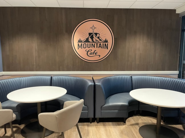 High-end dimensional emblems engineered to seamlessly blend with premium interior wall treatments like raw wood and stone.