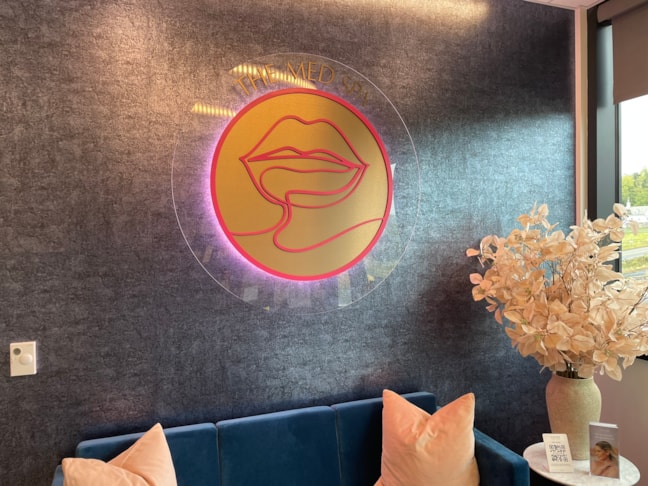 Luxury interior dimensional logo signage for a medical spa. Custom-designed wall branding that creates a high-end, welcoming lobby environment. Acrylic Signs w/ stand-offs