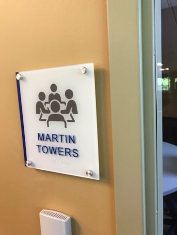 Clean, high-visibility directional signage engineered for seamless interior wayfinding compliance. ADA compliant
