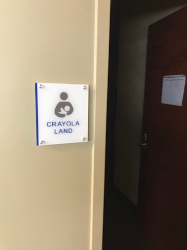 Custom interior wayfinding panels designed to maintain cohesive branding across sprawling office layouts.