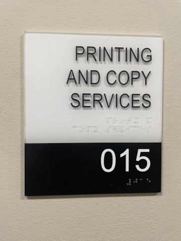 Custom architectural boardroom signage utilizing premium architectural standoffs, sub-surface color bars, and grade 2 dome Braille beads. ADA Signage & Compliance – Allentown Lehigh Valley PA