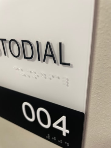 Custom architectural boardroom signage utilizing premium architectural standoffs, sub-surface color bars, and grade 2 dome Braille beads. ADA Signage & Compliance – Allentown Lehigh Valley PA