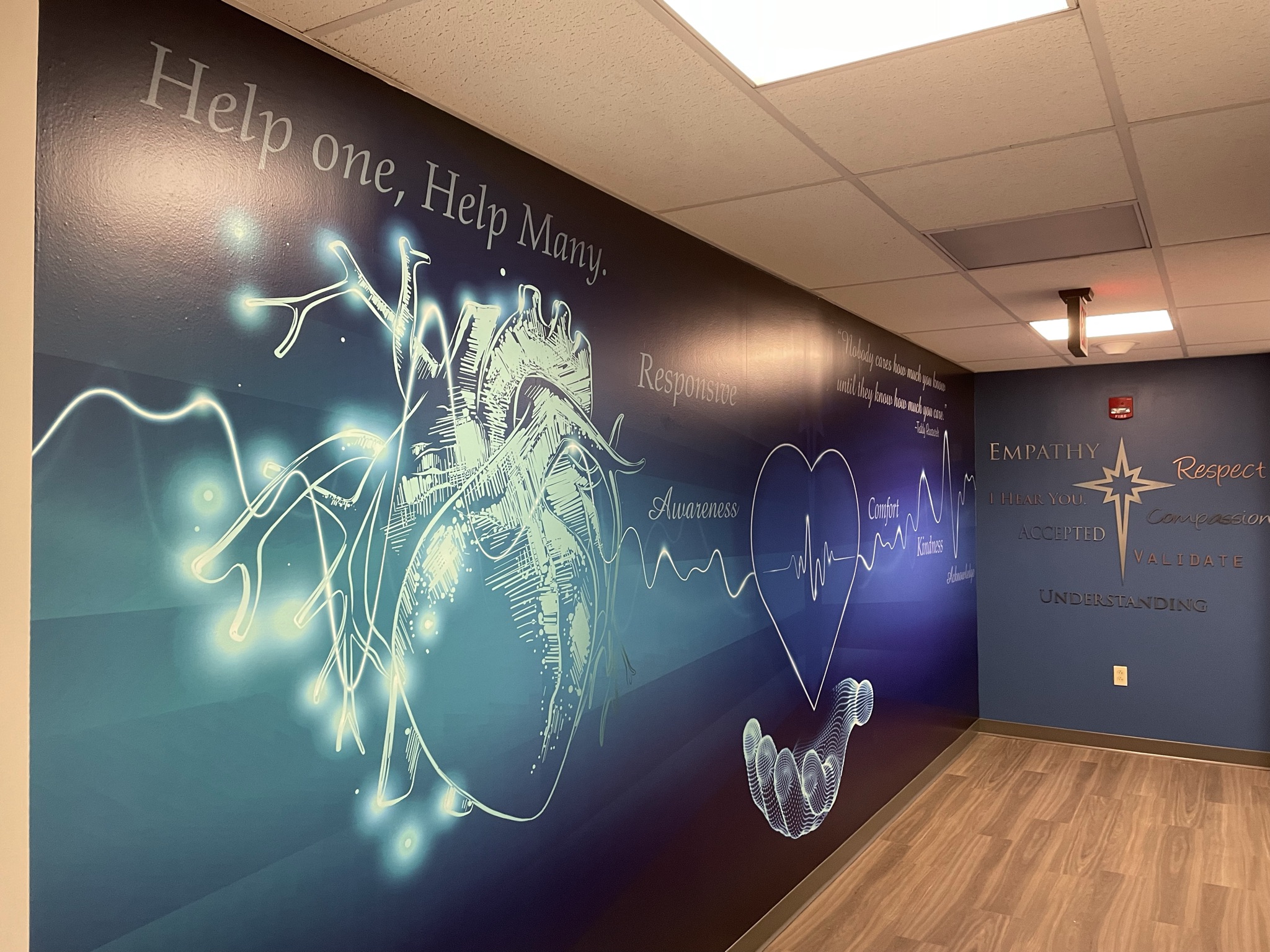 High-durability wall wraps transform standard hallways into cohesive, brand-aligned environments.