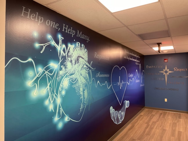 High-durability wall wraps transform standard hallways into cohesive, brand-aligned environments.