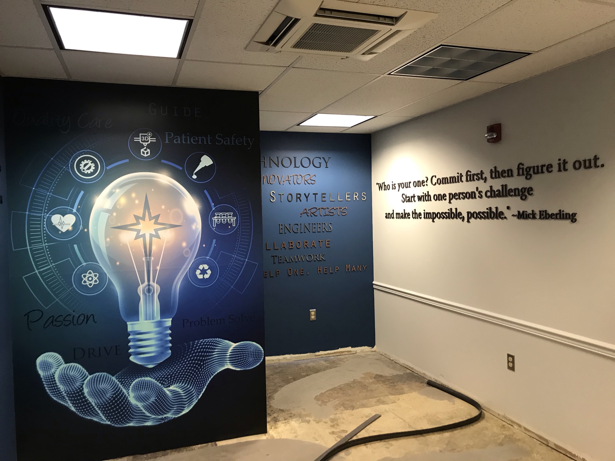 A custom vinyl wall mural featuring a glowing digital lightbulb graphic symbolizing medical innovation and ideas.
