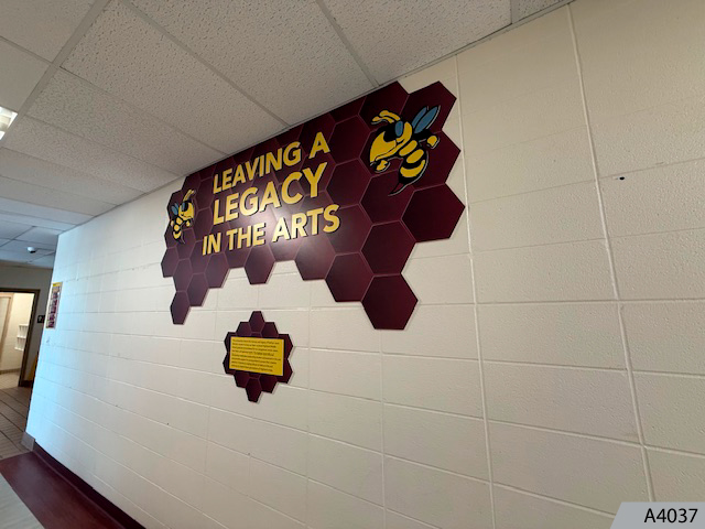 Combining specialized vinyl film for cinder block walls, and raised graphics to honor your best students.