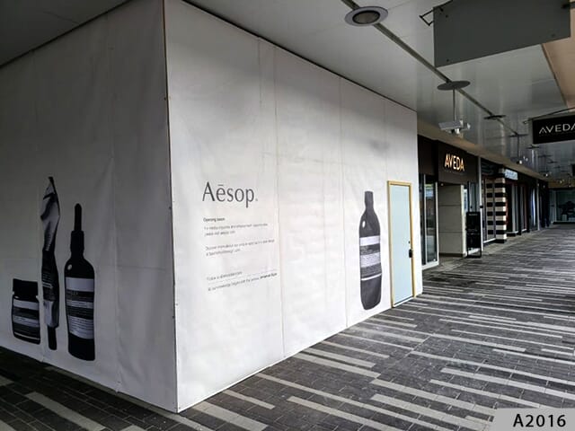 Perfect for barricades at shoping centers, mesh banners can display an attractive coming soon image.