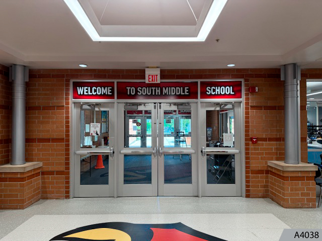Welcoming signage on the entrance door and window glass.