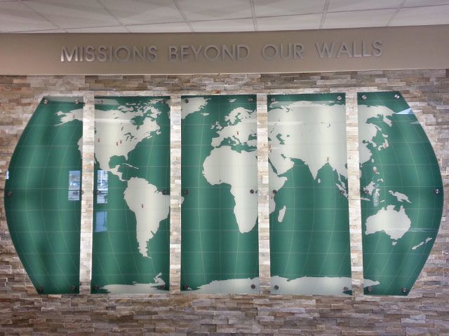 PlexiGlass with Brushed Steel Standoffs on Brick Over Lighting.