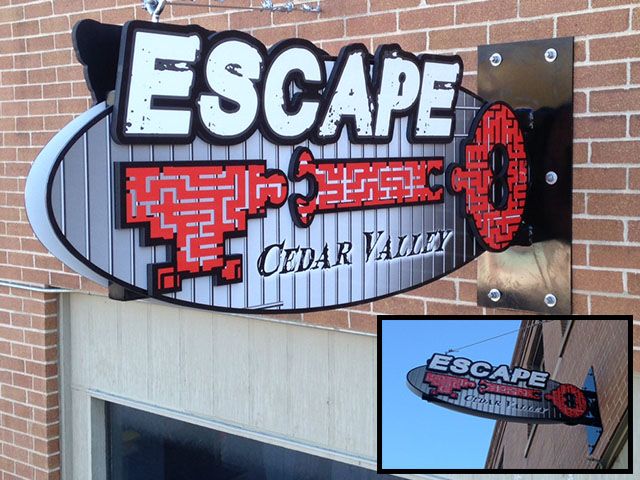 Multi-layered Sign Supported by Cable and a Bracket Bolted to Brick