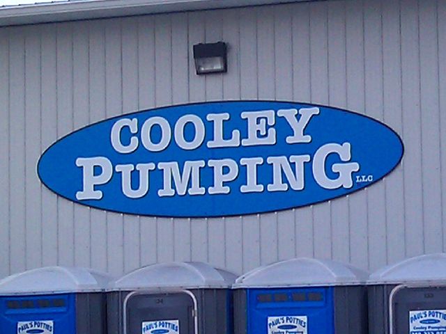 Outdoor company identification sign installed on building.