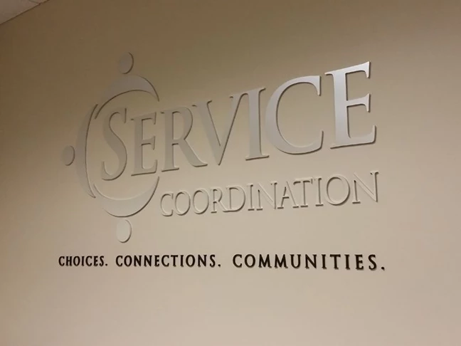 Brushed Silver and Black Acrylic Reception Area Lettering for Service Coordination
