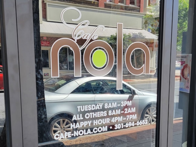 Door Logo & Hours for Cafe Nola